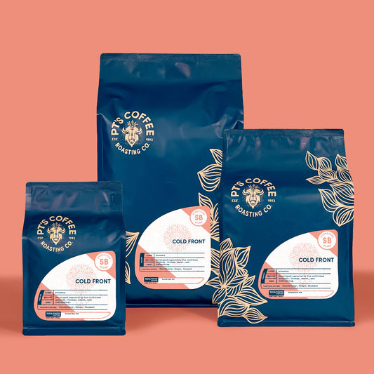 Blue Cold Front Signature Blend coffee bags arranged on a warm coral background