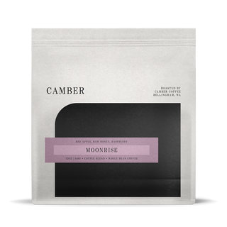 Camber Coffee Moonrise blend bag with lavender label on a light bag over a black rounded inset.