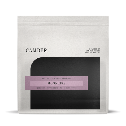 Camber Coffee Moonrise blend bag with lavender label on a light bag over a black rounded inset.