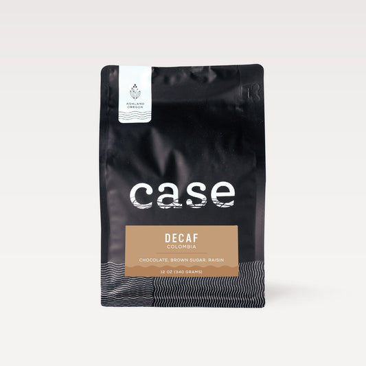 Decaf Colombia Case Coffee Roasters bag with white Ashland Oregon label on a black pouch