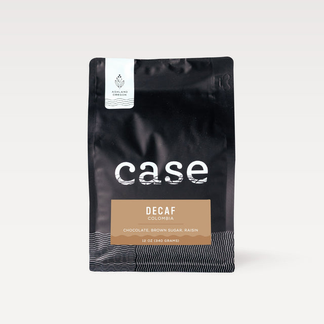 Decaf Colombia Case Coffee Roasters bag with white Ashland Oregon label on a black pouch