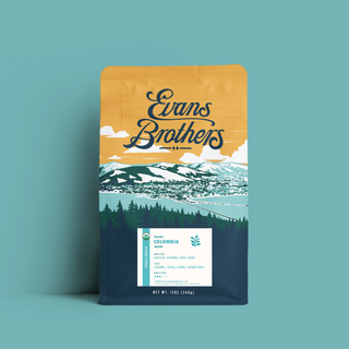 Colombia Nariño coffee bag shown against teal backdrop with landscape artwork and certification label