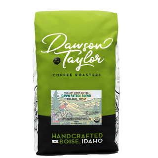 Green Dawn Patrol coffee bag with white Dawson Taylor script logo and Boise Idaho handcrafted label