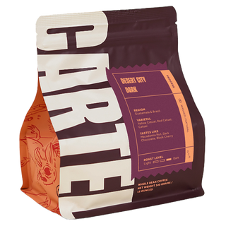 Desert City Dark coffee bag with a bold label on a purple panel and orange accent tabs.
