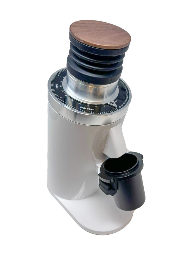 Front view of Turin DF64 Gen 2.5 single dose grinder with white body silver dial and portafilter cradle