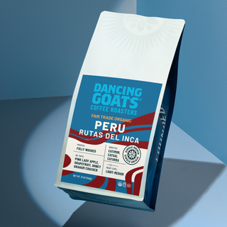 Peru Rutas Del Inca coffee bag tilted against a blue backdrop with red banner and white label details