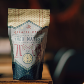 Partial shot of Laid Back Decaf coffee bag showing chevron pattern and clock emblem.