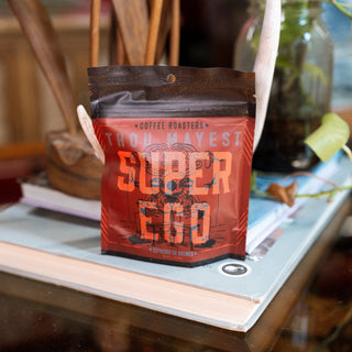Super Ego coffee bag with dark roast packaging and bold Thou Mayest branding.