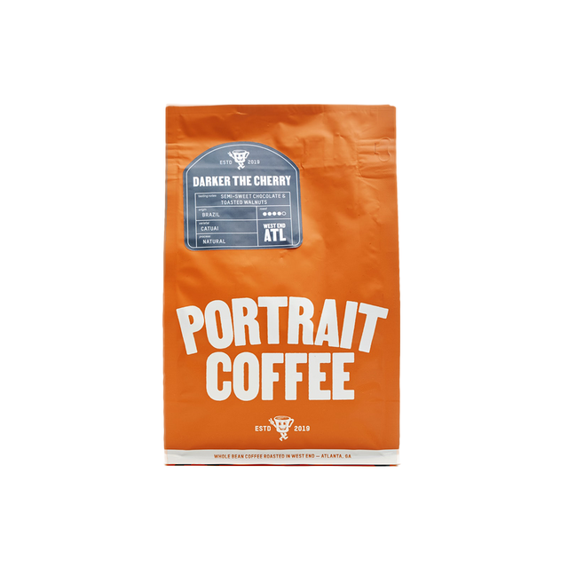 Orange Portrait Coffee bag centered on a black background.