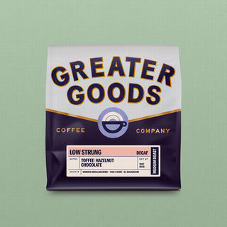 Greater Goods Low Strung Decaf coffee bag on a green background displaying flavor notes Toffee Hazelnut Chocolate