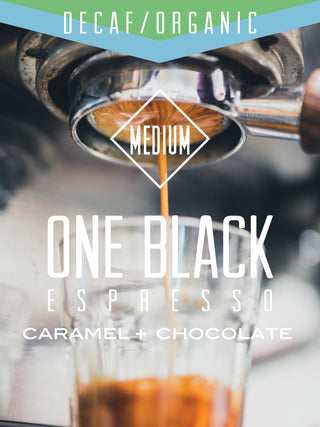 Espresso pours from a portafilter into a glass with a Decaf Organic One Black Espresso label and a MEDIUM roast badge