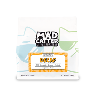 Decaf Colombia sugarcane process coffee bag with bold orange label and notes of milk chocolate orange