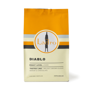 Diablo coffee bag with Ladro logo and orange yellow design on pale packaging