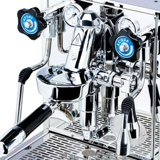 Close-up of the ECM Mechanika Slim PID espresso machine chrome front with gauges and blue Vapore and Acqua knobs.