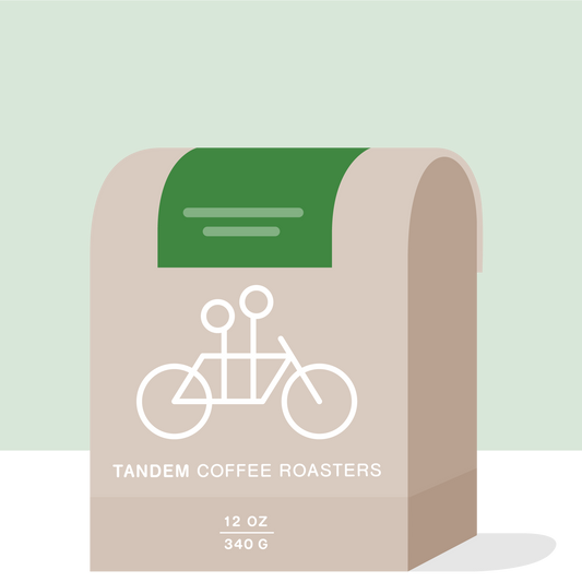 Sidra Lot 2 Colombia coffee packaging on a green background with beige decorative curves and Tandem branding