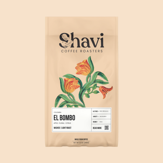 Partial view of a beige El Bombo coffee bag by Shavi Coffee Roasters with a botanical leaf design