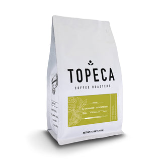 Topeca coffee bag from Ayutepeque El Salvador with white packaging and a gold tasting notes panel