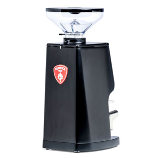 Eureka Atom W 75 espresso grinder with a clear hopper and black body featuring a red Eureka crest.
