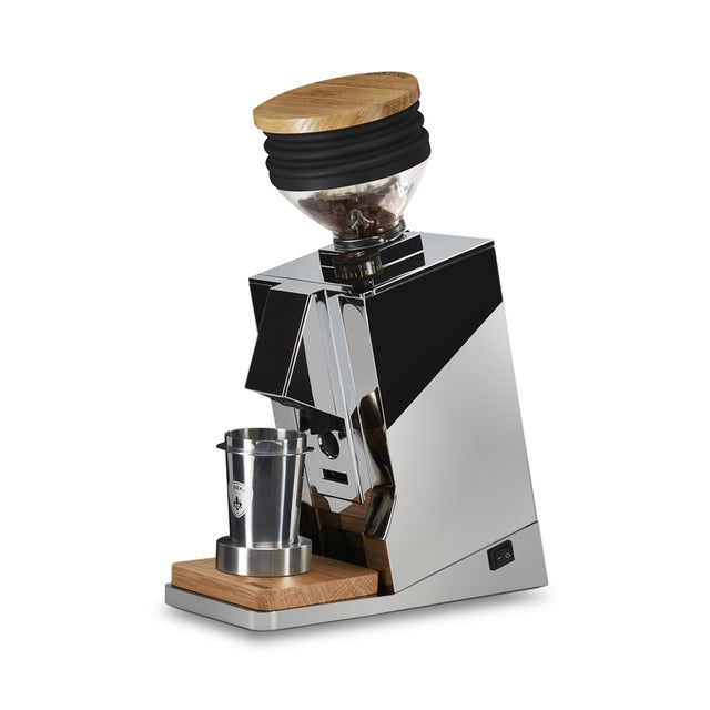 Open box Eureka Oro Mignon single dose espresso grinder with wood lid and chrome body.