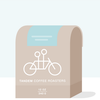 Tandem Coffee Roasters bag for Faver Ninco Gesha Colombia featuring a white bicycle illustration on a beige bag
