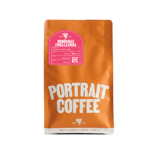 Orange coffee bag labeled Honduras Finca La Unica Natural with a pink tasting notes panel