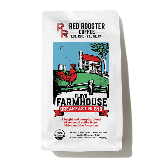 Golden mug beside Organic Floyd Farmhouse Breakfast Blend bag on a cafe counter