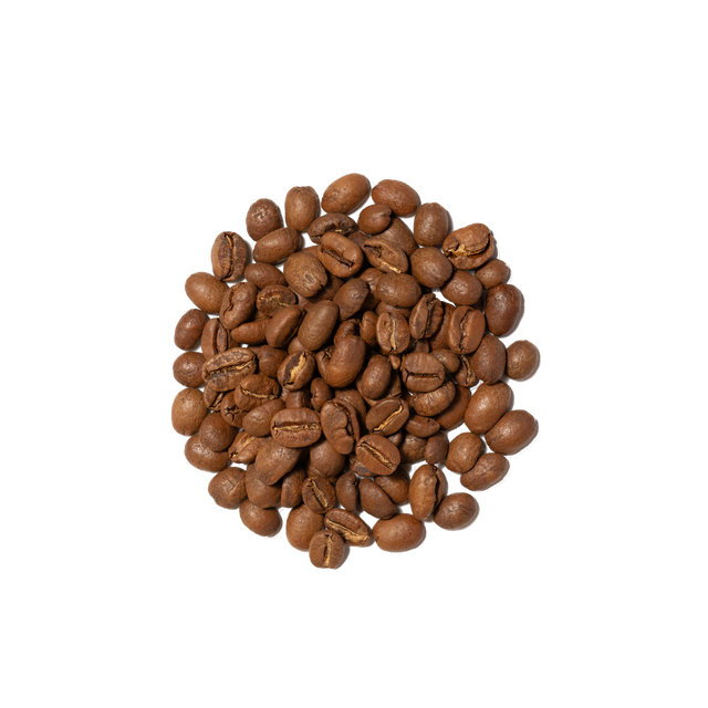 Close up of roasted coffee beans spilled beside a white bag labeled Farmhouse Breakfast Blend
