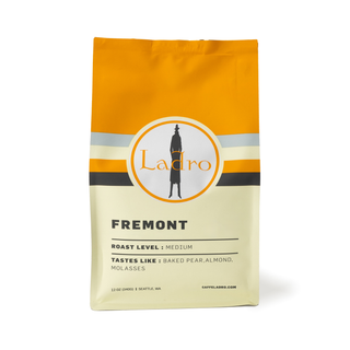 Ladro Fremont coffee bag with an orange top and circular logo on the label