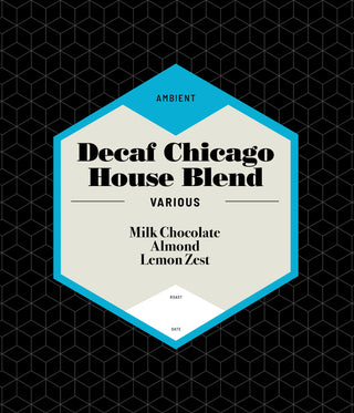 Decaf Chicago House Blend coffee bag with cream label and blue frame on a black geometric bag