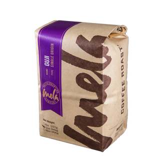 Bag of Ethiopia Guji Kercha coffee with a purple label and brown decorative print
