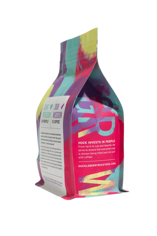 Skeleton Key Decaf coffee bag with bright abstract artwork and a folded top.