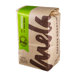 Honduras COCAFCAL Las Capucas coffee bag with a bright green label on kraft paper