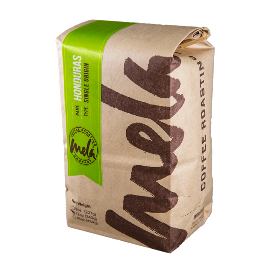 Honduras COCAFCAL Las Capucas coffee bag with a bright green label on kraft paper