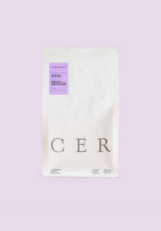 White Ceremony coffee bag with lavender label and large CER lettering on a pale lavender backdrop