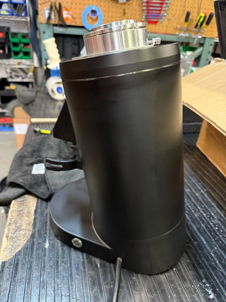 Front view of the DF83 single dose coffee grinder with chrome cap and black base on a shop table
