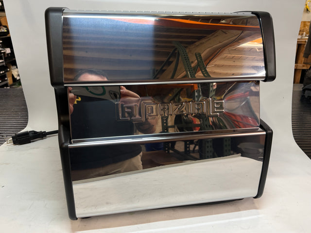 Open box Lucca A53 Mini espresso machine with chrome front and black frame on a white display surface