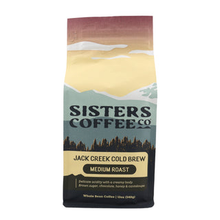 Front view of Jack Creek Cold Brew bag featuring mountain landscape and Sisters Coffee Co branding with Medium Roast label.
