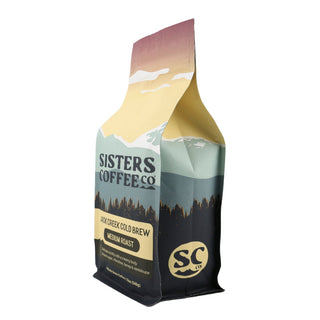 Angled side view of Jack Creek Cold Brew bag with mountain landscape and branding.
