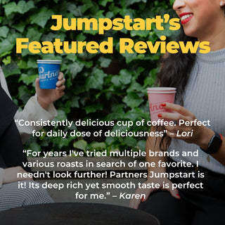 Two people enjoy coffee outdoors with a green leafy backdrop and a Jumpstart Featured Reviews banner in bold yellow letters