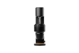 The Key Mk2 black grinder head shown against a dark background with burr housing and numbered dial
