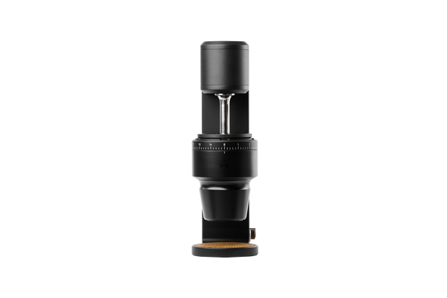 The Key Mk2 black grinder head shown against a dark background with burr housing and numbered dial