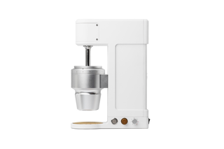 Side view of The Key compact white coffee grinder with exposed burr assembly and calibration dial.