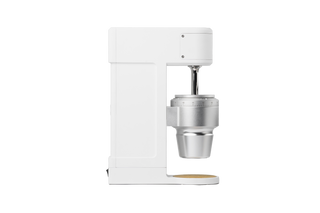 Side view of The Key compact white coffee grinder with metal burr housing and a numbered grind setting dial.