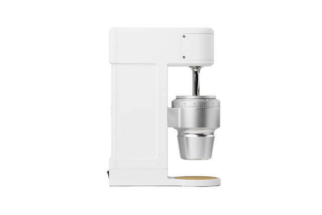 Side view of The Key compact white coffee grinder with metal burr housing and a numbered grind setting dial.