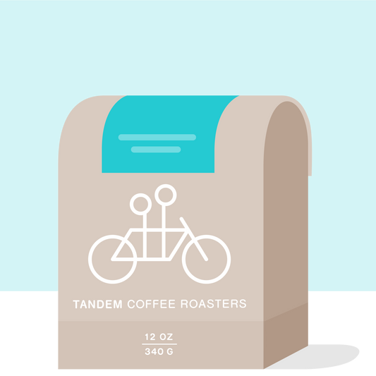 La Piramide Colombia packaging with turquoise backdrop beige curves and Tandem branding
