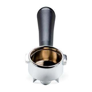 Close-up of a black LUCCA A53 spouted portafilter above the metal basket against a white background.