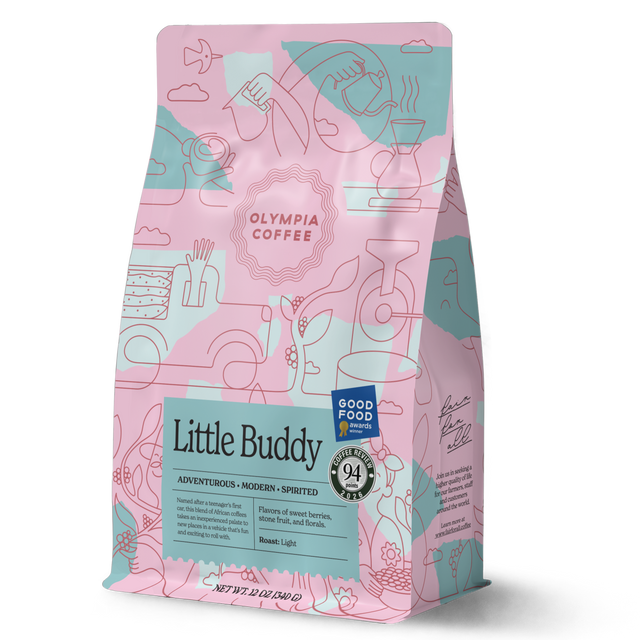 Little Buddy coffee bag from Olympia Coffee Roasting Company with colorful pink and teal artwork and award badges
