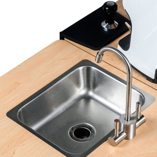 Top view of the cart workspace showing a stainless sink with curved faucet and a black tray on a light wood counter