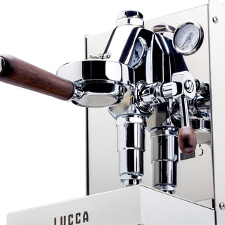 Close-up of LUCCA Solo espresso machine chrome group head and wooden portafilter