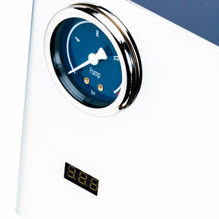 Close up of LUCCA Tempo blue pump gauge with white hand and digital readout below on chrome machine